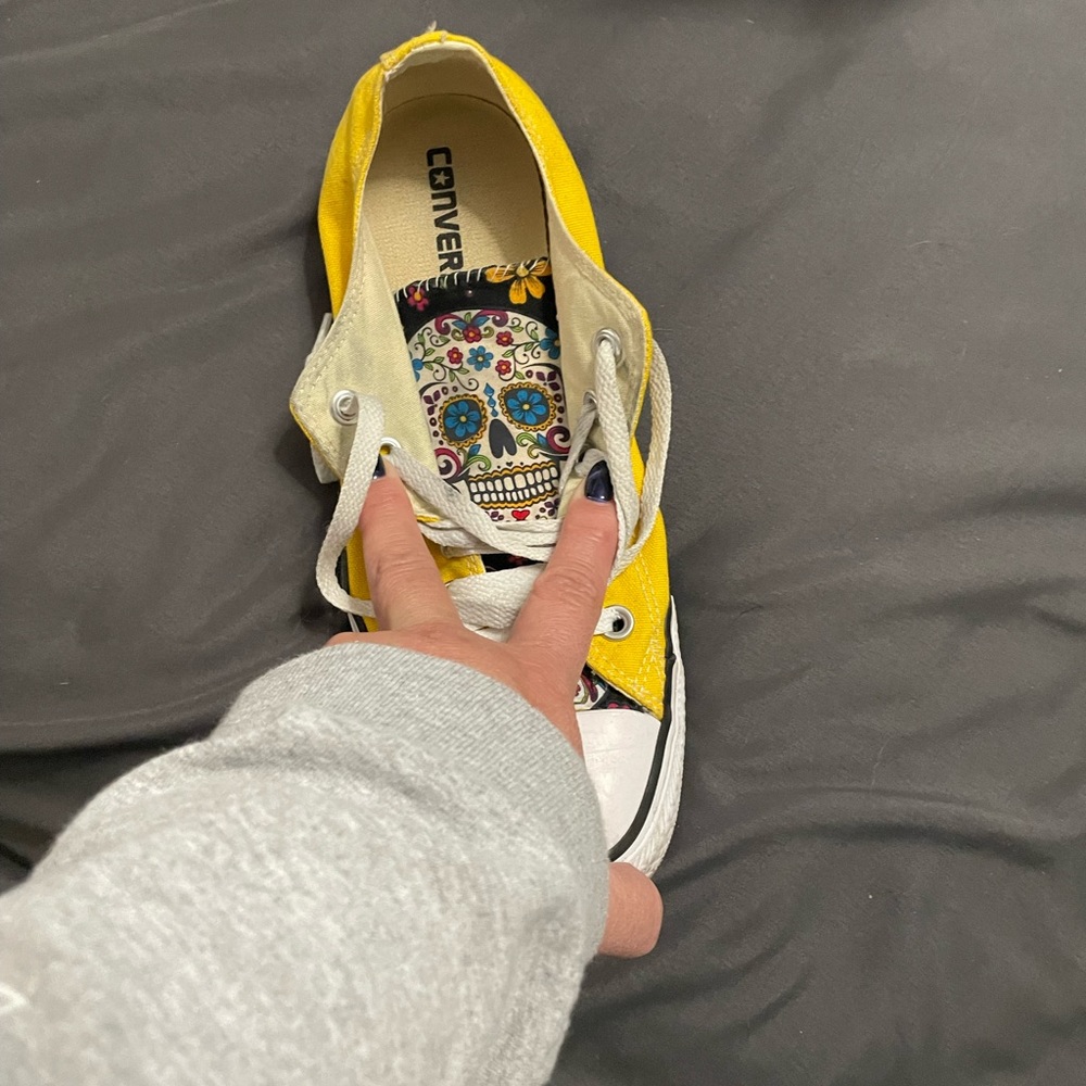 Yellow Converse with day of the dead sewed onto the tongue
